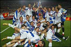 The ecstatic Greek players celebrate with the trophy