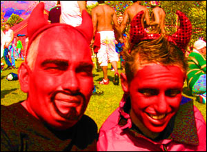 Two revellers wear devil outfits