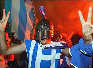 A Greek fan celebrates outside City Hall early on Monday