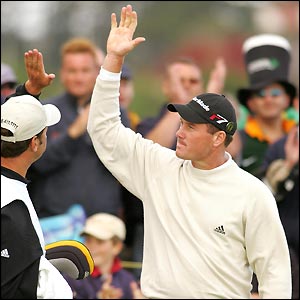 Todd Hamilton high-fives with his caddie after a fine birdie at the 14th
