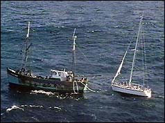 A stricken yacht is towed to safety