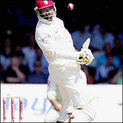 WI's opening batsmen Chris Gayle avoids a bouncer as he looks comfortable on a flat Lords pitch