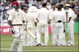 West Indies' Dwayne Bravo walks from the crease after being dismissed by Ashley Giles