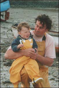 Elen Owen's 14-month-old son Owain with his father Kevin in Porthdinllaen Morfa Nefyn