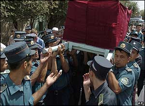 Police officers carry the body of fellow officer Ikhtiyar Khakimov at his funeral