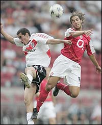 Arsenal's Matthieu Flamini jumps for a header 