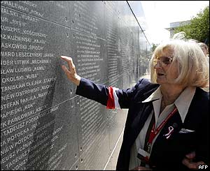 An elderly veteran of the uprising looks at the wall with names of dead insurgents
