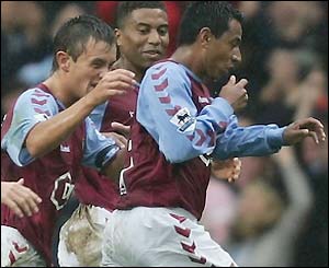 Aston Villa's players rush to congratulate Nolberto Solano after his 29th-minute goal