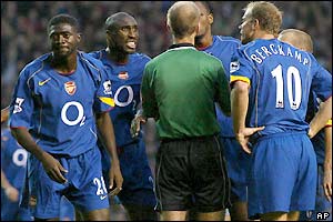 Arsenal's players show their disappointment and disbelief after Mike Riley's decision