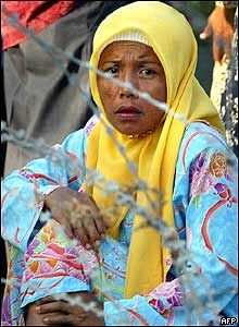 A relative of a demonstrator waits in front of a military camp in Pattani province, 26 October 2004 