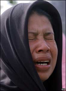 A woman bursts into tears after learning from the list that her family member is dead, 27 October 2004.