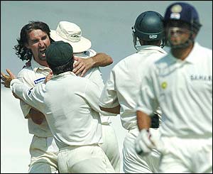 Gillespie is congratulated by his team-mates after removing Sachin Tendulkar