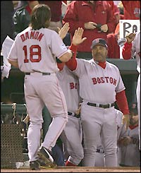 Johnny Damon celebrates with team-mates after completing his home run