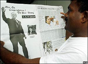 Sri Lankan businessman with newspaper advert congratulating George W Bush