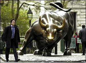 Man walks past statue of charging bull near New York Stock Exchange on Election Day