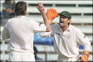 Adam Gilchrist congratulates team mate Glenn McGrath on the wicket of Gautam Gambhir 