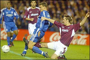 Schalke's Ebbe Sand is tackled by Hearts' Andy Webster 