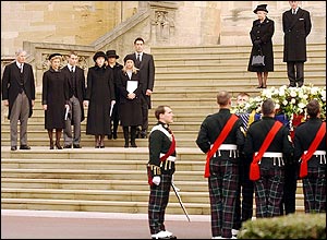 Royal family watch the coffin go into the hearse