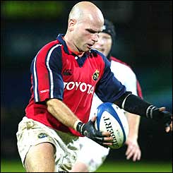 Munster fly-half Paul Burke about to clear his lines