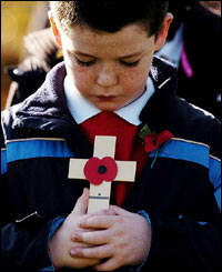 A Britannia School pupil held a cross of remembrance during a ceremony at the Fields of Honour Cemetery, Ipswich. 
