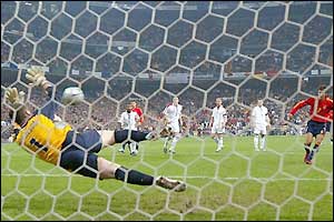 The England defenders look on as Paul Robinson saves Raul's penalty