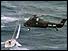 Helicopter rescuing yacht crew 