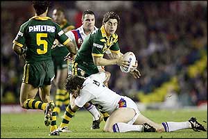 Paul Wellens attempts a tackle on Anthony Minichiello as Australia start impressively