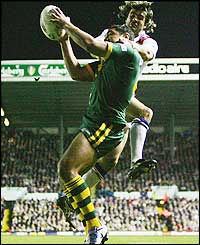 Willie Tonga plucks the ball from Brian Carney's grasp after a high ball and scores