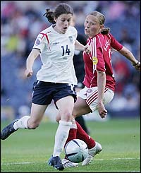 Karen Carney skips past Mariann Knudsen 