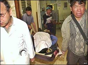 A doctor (right) and miners carry the body of their colleague in Yolata, near Sucre