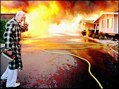 A dazed resident surveys the damage