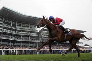Jockey Mick Kinane and Peeress pass the grandstand