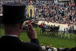 A man photographs the Royal procession