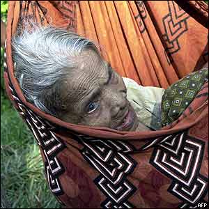 An old woman is carried to safety Car Nicobar island in the Andamans.