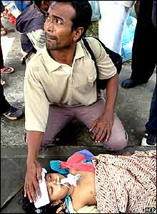 Father with injured daughter in Aceh, Indonesia