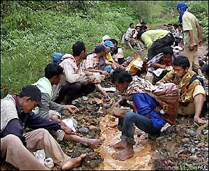 Indonesians eating food brought to them by an AFP photographer on his motorbike.