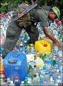 Sri Lankan soldier checks donated water