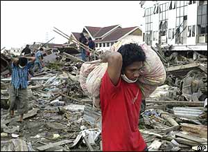Survivors retrieve Friday, Dec. 31, 2004, their belongings from the devastated commercial district of Banda Aceh
