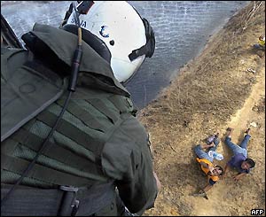 US navy personnel give food and water supplies to refugees, 2 Jan
