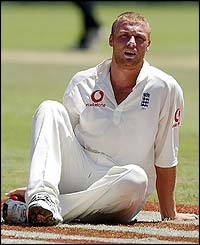 England's Andrew Flintoff takes a break on the outfield