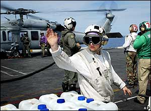 Water aid being prepared for delivery on US aircraft carrier Abraham Lincoln