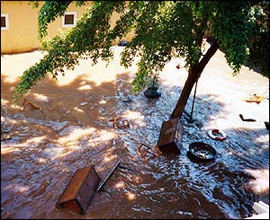 Flood waters swirling around debris