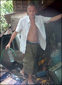 Duncan Wilson in ruins of homes in Sri Lanka