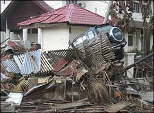 Vehicle on top of piled debris in Meulaboh