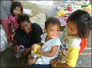 Children in a refugee camp with their gifts