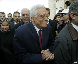 Palestinian presidential candidate Mahmoud Abbas, followed by his wife Amina (left) leaves the Muqataa polling station in Ramallah