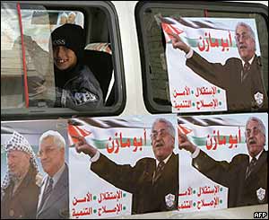 Palestinians boy looks from a vehicle covered with campaign posters of presidential candidate Mahmoud Abbas, Abu Dis, West Bank