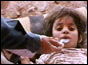 Young earthquake survivor is fed with a spoon