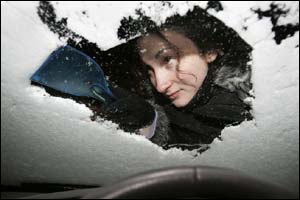 Woman clearing windscreen