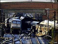 Wreckage of two trains under road bridge